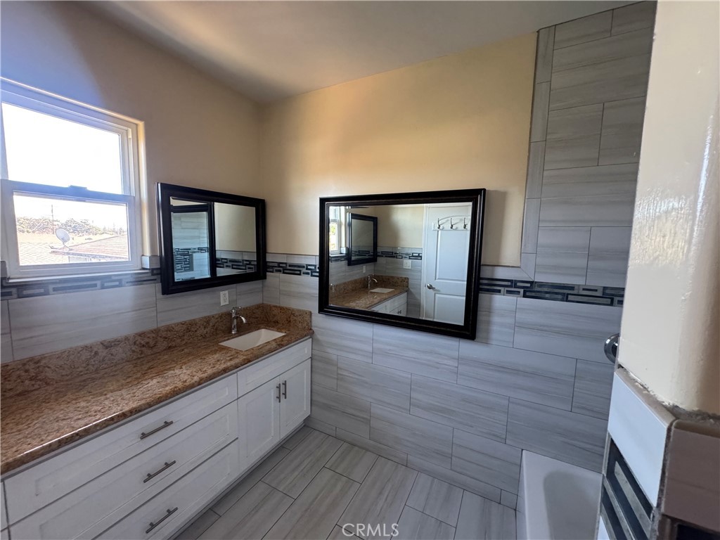 3533 West 109th Street, Unit 1/2 Inglewood, CA 90303 - Photo 19 of 26 a kitchen with granite countertop a sink and a granite counter top