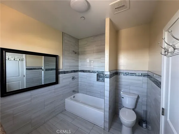 a bathroom with a toilet and a tub