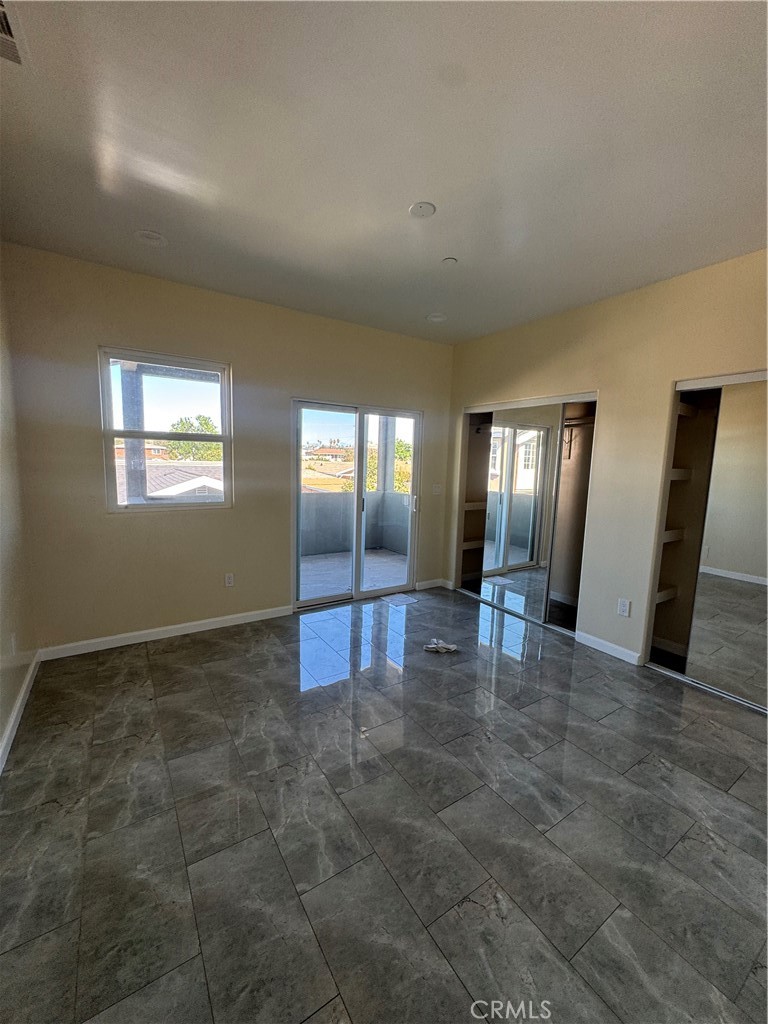 3533 West 109th Street, Unit 1/2 Inglewood, CA 90303 - Photo 25 of 26 an empty room with windows and fireplace