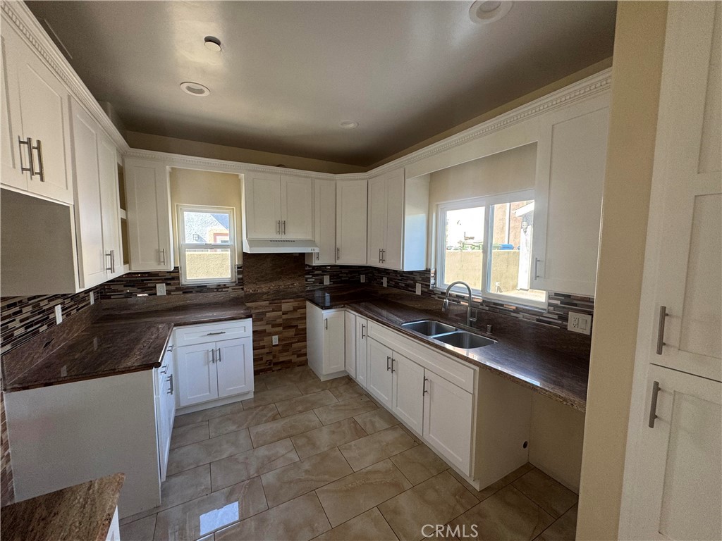 3533 West 109th Street, Unit 1/2 Inglewood, CA 90303 - Photo 3 of 26 a large kitchen with stainless steel appliances granite countertop a sink and cabinets