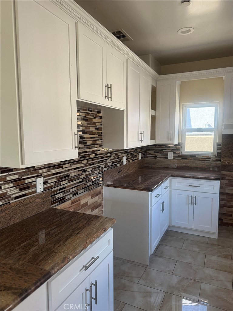 3533 West 109th Street, Unit 1/2 Inglewood, CA 90303 - Photo 4 of 26 a kitchen with granite countertop a stove sink and cabinets