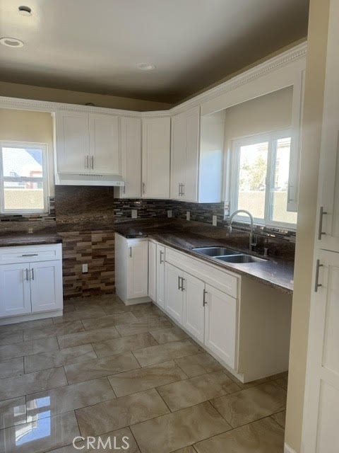 3533 West 109th Street, Unit 1/2 Inglewood, CA 90303 - Photo 5 of 26 a kitchen with granite countertop a sink a stove and cabinets
