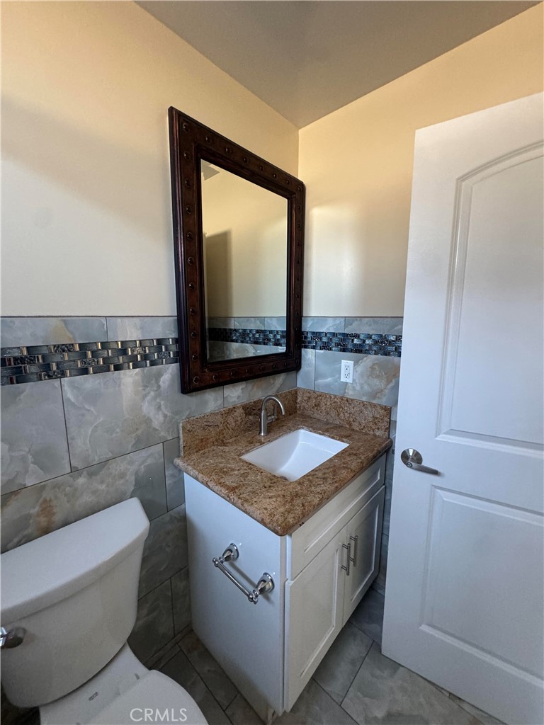 3533 West 109th Street, Unit 1/2 Inglewood, CA 90303 - Photo 10 of 26 a bathroom with a granite countertop sink and a mirror