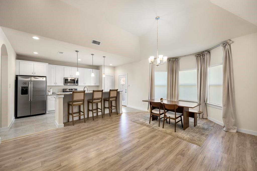 2815 East Overton Road Dallas, TX 75216 - Photo 14 of 23 a view of a dining room with furniture window and wooden floor