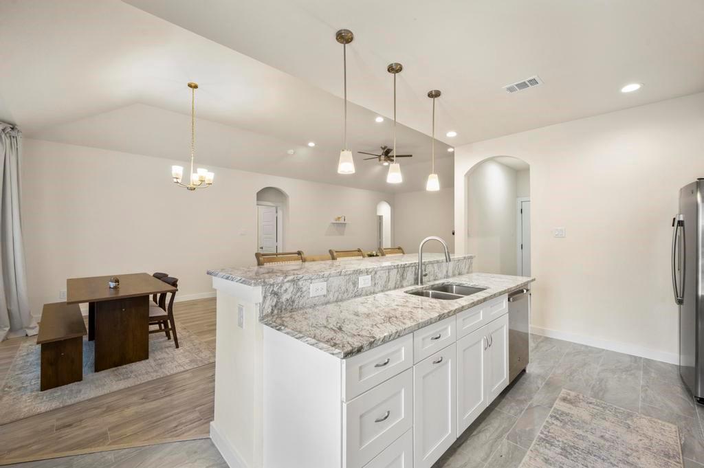 2815 East Overton Road Dallas, TX 75216 - Photo 19 of 23 a bathroom with a granite countertop sink a large mirror and a shower