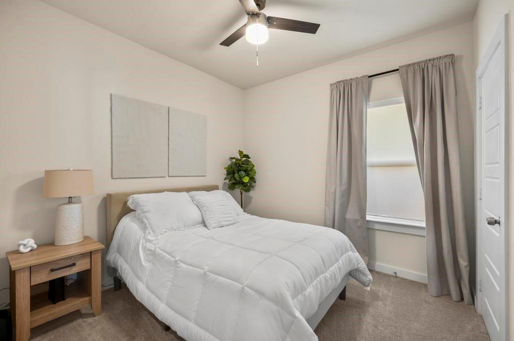 2815 East Overton Road Dallas, TX 75216 - Photo 5 of 23 a bedroom with a bed and a window