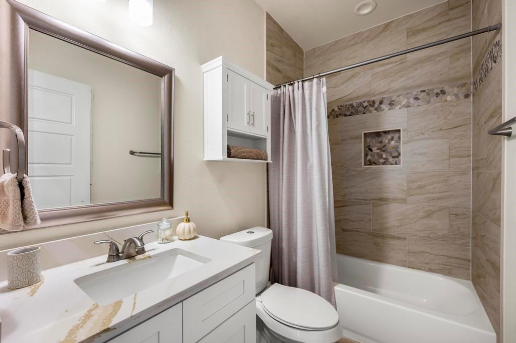 2815 East Overton Road Dallas, TX 75216 - Photo 6 of 23 a bathroom with a sink toilet and shower