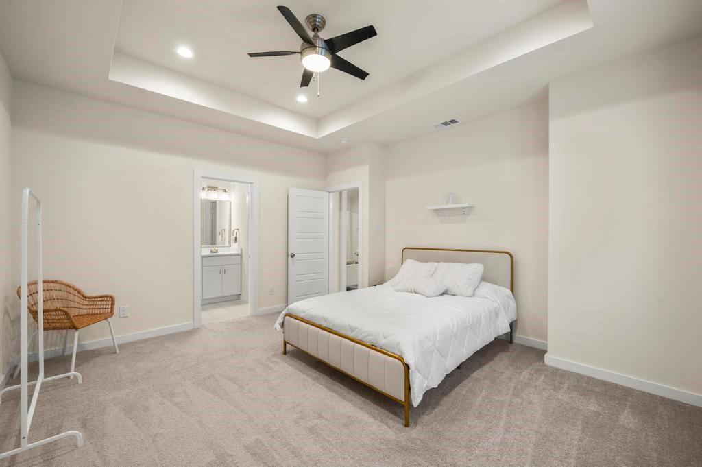 2815 East Overton Road Dallas, TX 75216 - Photo 8 of 23 a spacious bedroom with a bed and a ceiling fan