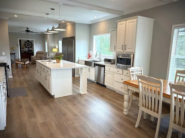 a bathroom with a granite countertop sink a vanity and a shower