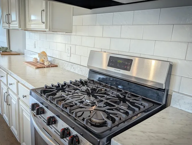 a bath tub sitting in a bathroom next to a window