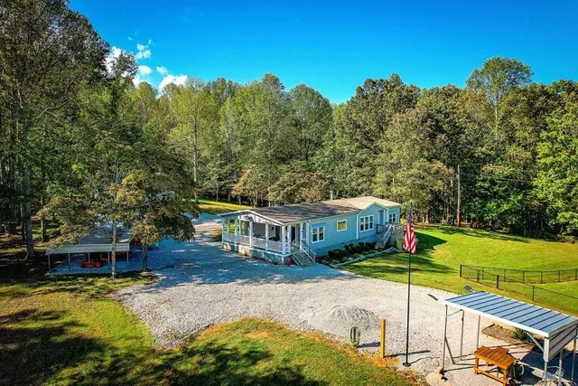 an aerial view of a house with a yard and garden
