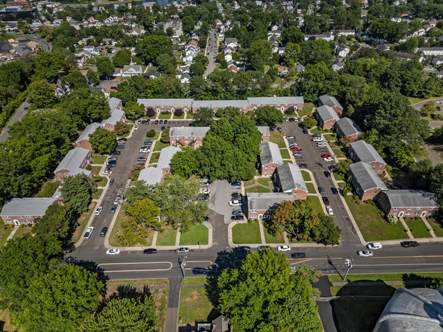 an aerial view of residential houses with outdoor space and street view