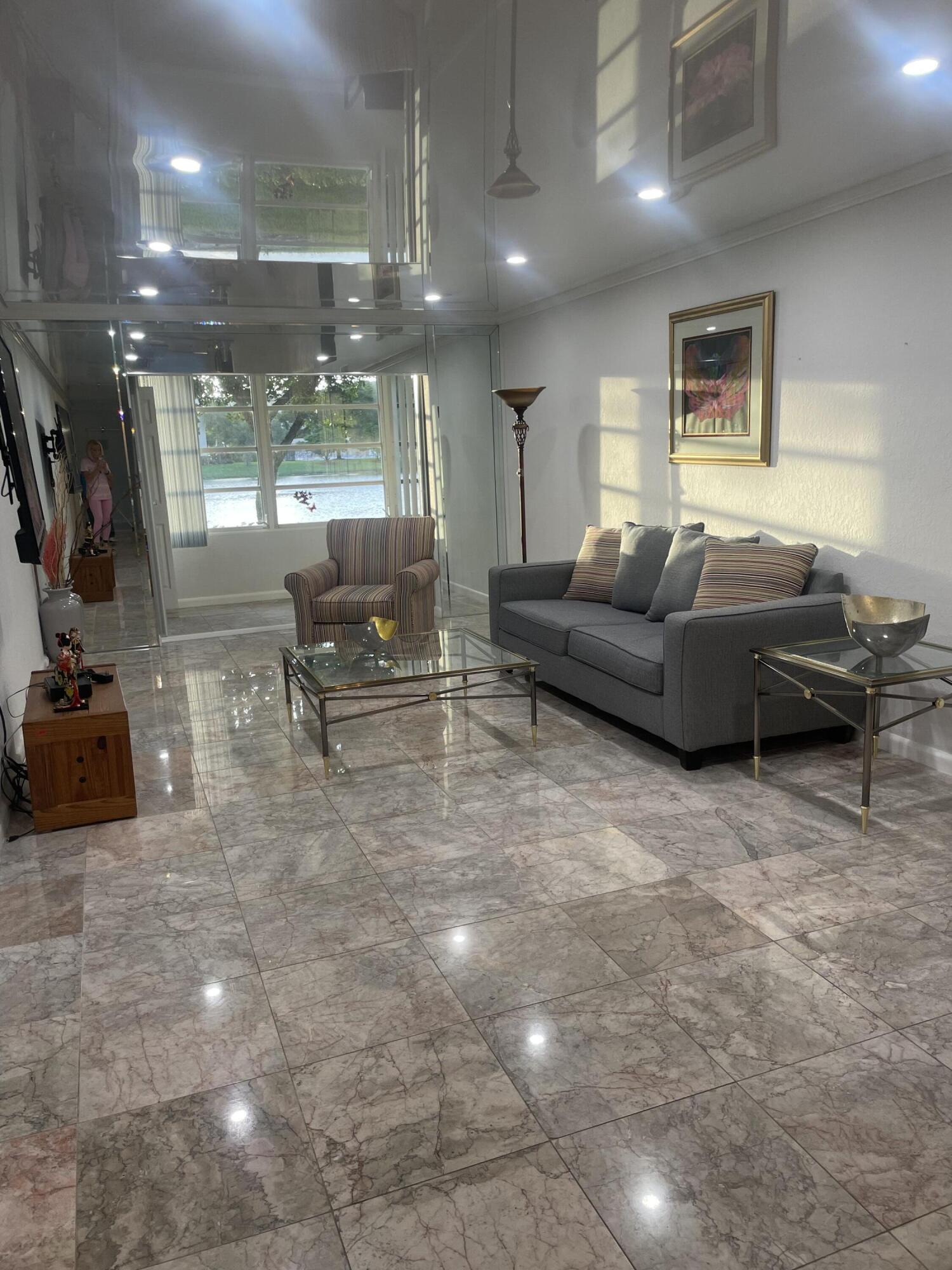 1904 Bermuda Circle, Unit H1 Coconut Creek, FL 33066 - Photo 16 of 72 a living room with furniture and a flat screen tv