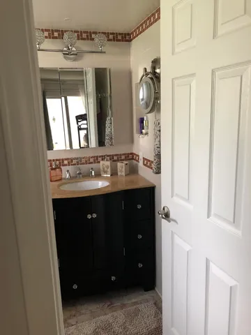 a bedroom with bed and a large window