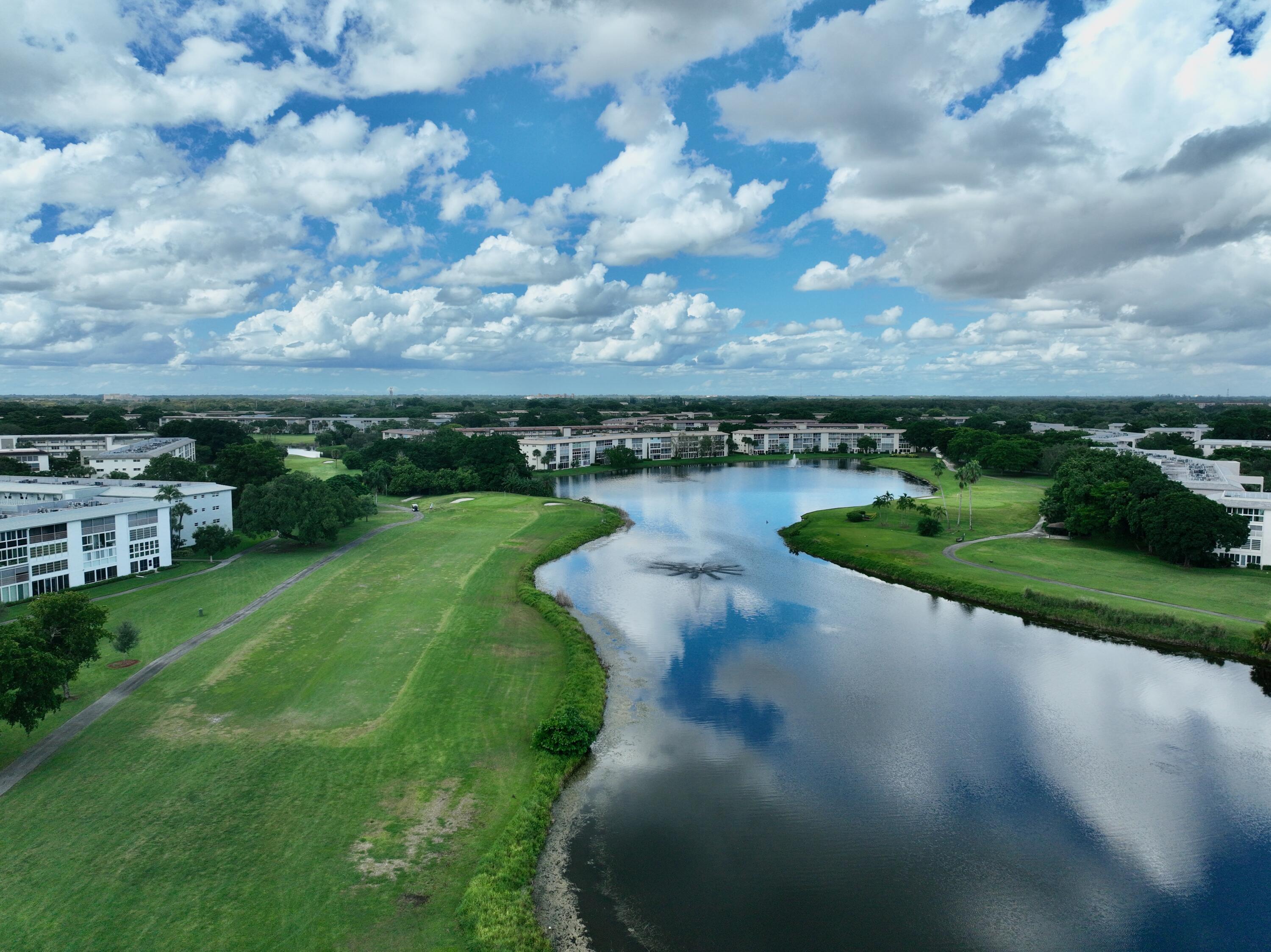 1904 Bermuda Circle, Unit H1 Coconut Creek, FL 33066 - Photo 57 of 72 a view of a lake with houses in the back