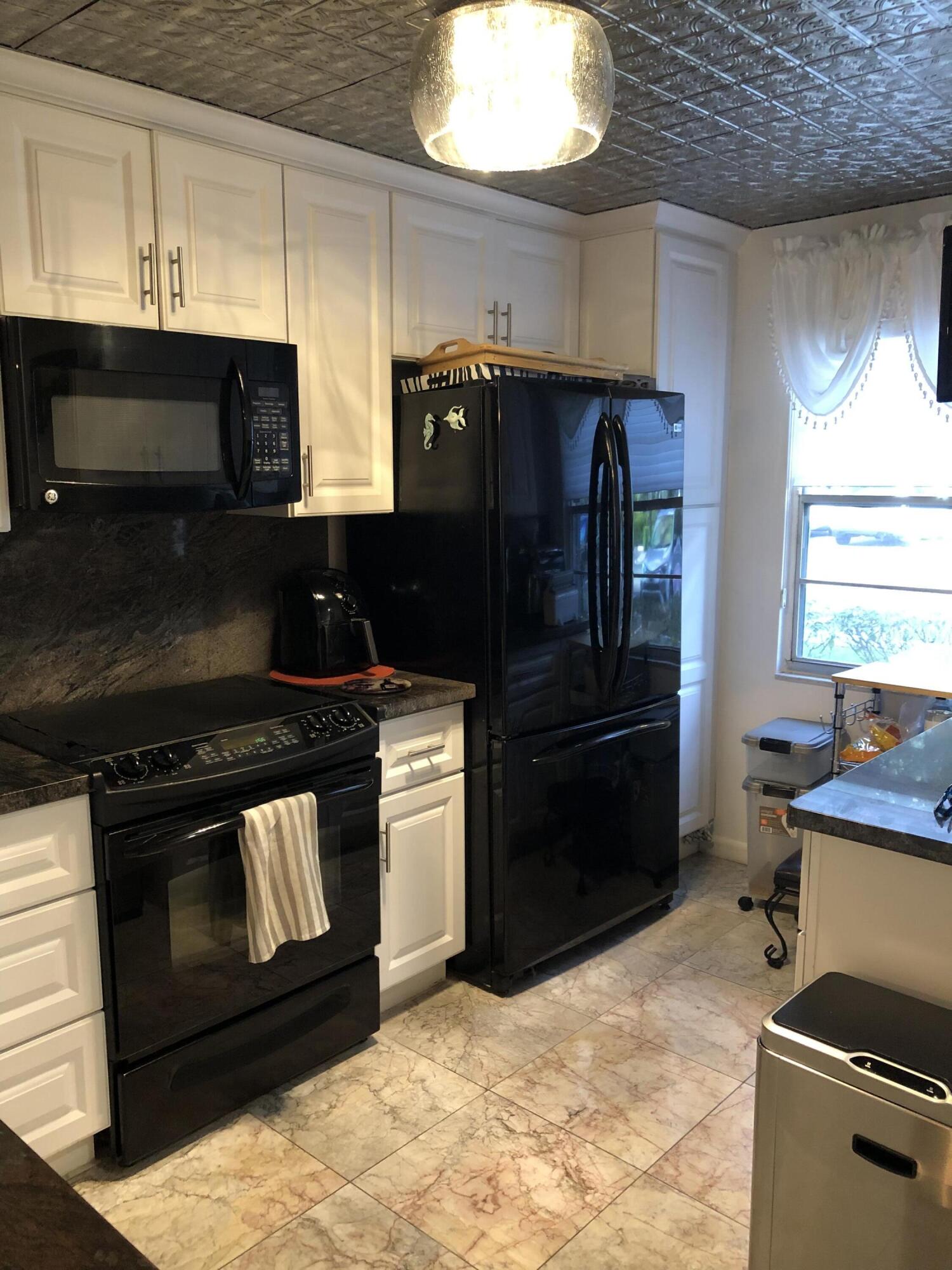 1904 Bermuda Circle, Unit H1 Coconut Creek, FL 33066 - Photo 7 of 72 a kitchen with stainless steel appliances granite countertop a stove a sink and a refrigerator
