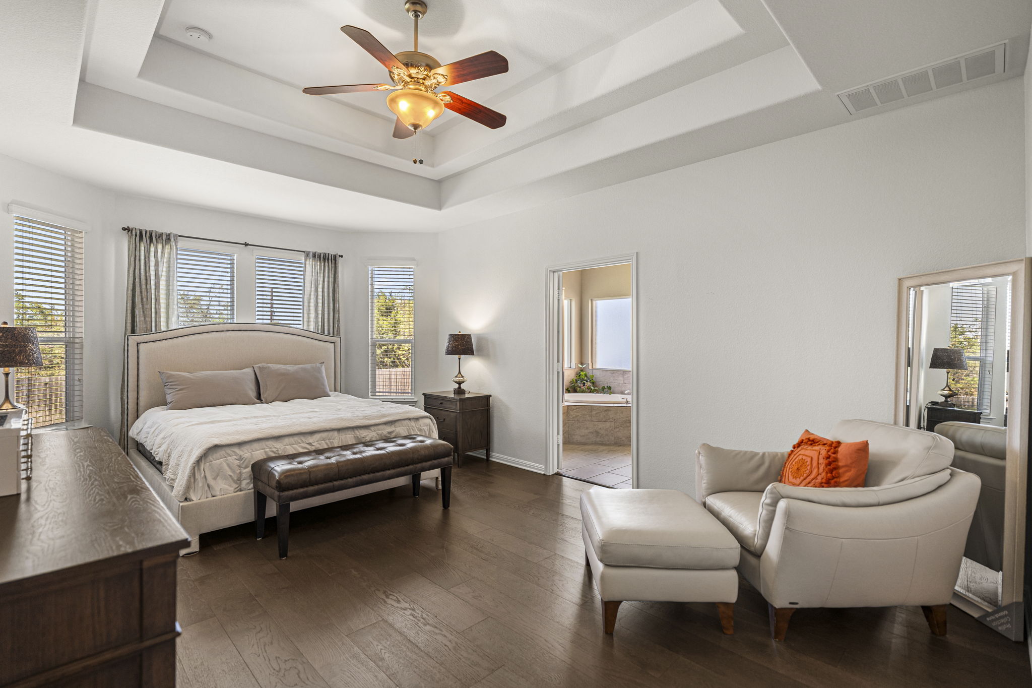 11412 Reading Way Austin, TX 78717 - Photo 11 of 35 Large primary bedroom downstairs with wood flooring and en suite bathroom.
