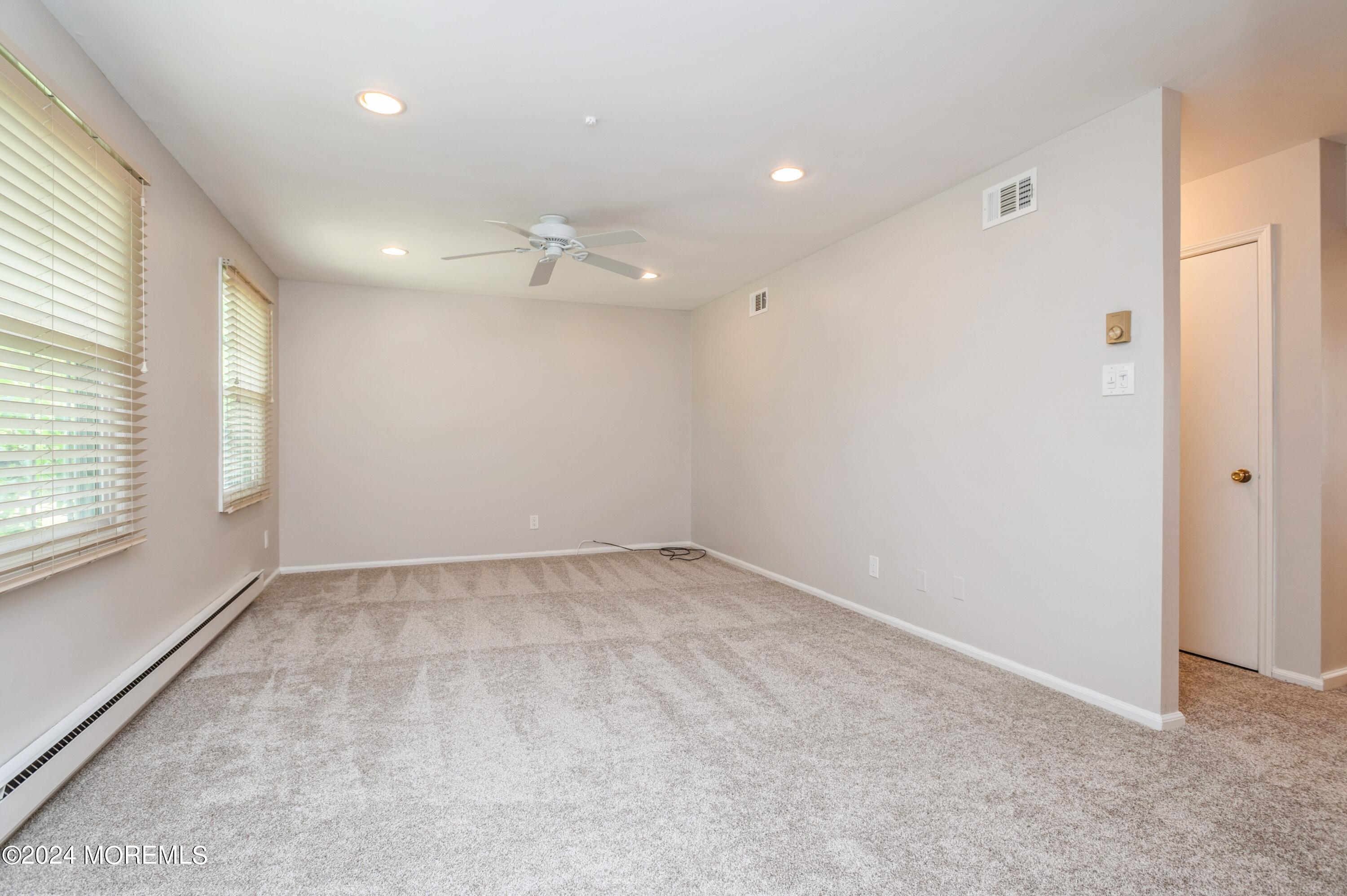 95 Halls Croft Road, Unit E Freehold, NJ 07728 - Photo 14 of 23 05_95HallsCroftRd_UnitE_10001_LivingRoom