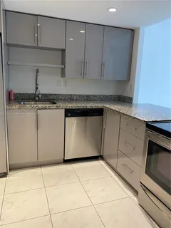a kitchen with granite countertop a cabinets and white appliances