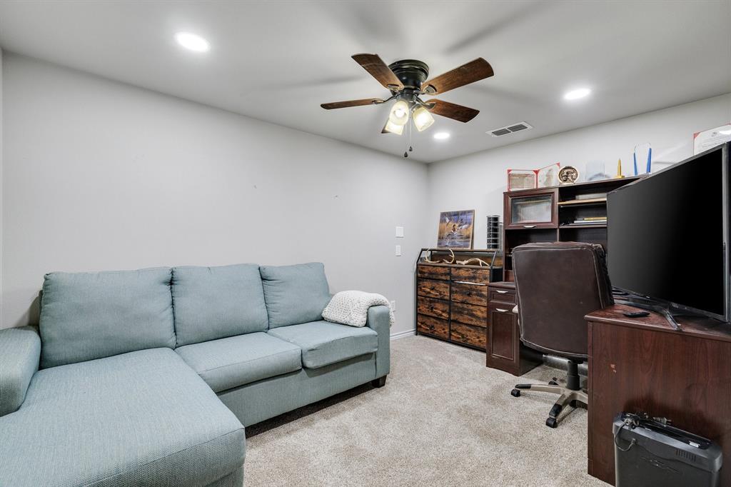 2668 Upper Montague Road Bowie, TX 76230 - Photo 21 of 40 a living room with furniture a ceiling fan and a flat screen tv