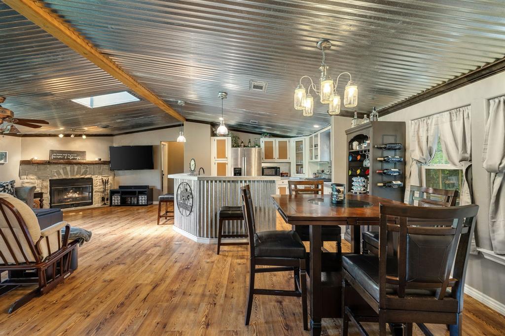 2668 Upper Montague Road Bowie, TX 76230 - Photo 25 of 40 a view of a dining room with furniture and a fireplace