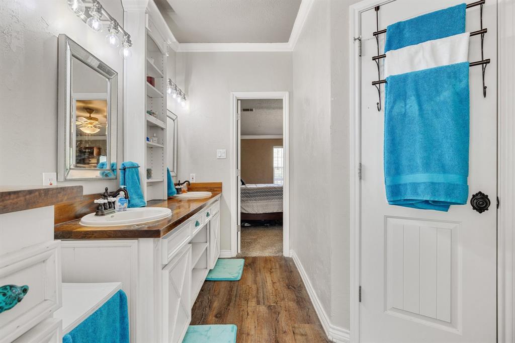 2668 Upper Montague Road Bowie, TX 76230 - Photo 29 of 40 a bathroom with a sink and a mirror