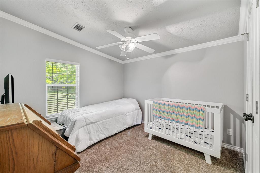 2668 Upper Montague Road Bowie, TX 76230 - Photo 32 of 40 a bedroom with a bed and a window