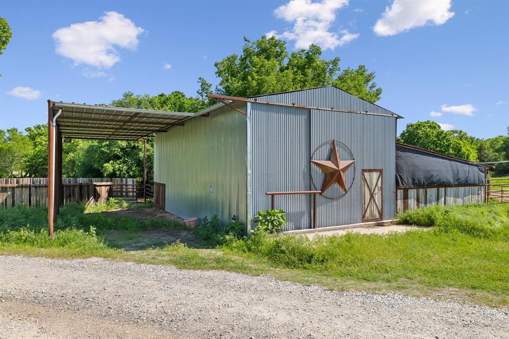 2668 Upper Montague Road Bowie, TX 76230 - Photo 36 of 40 a backyard of a house with plants and outdoor seating