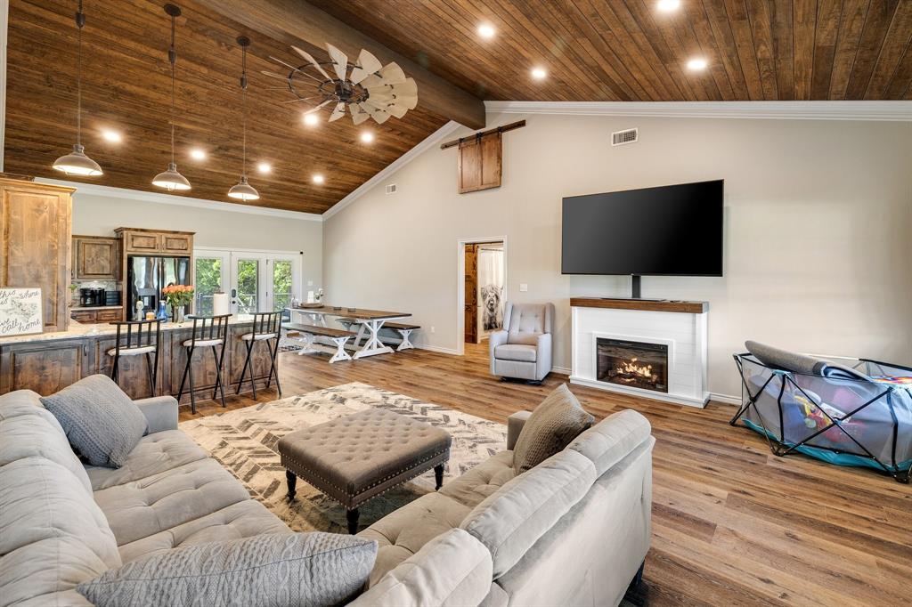 2668 Upper Montague Road Bowie, TX 76230 - Photo 6 of 40 a living room with furniture a fireplace and a flat screen tv