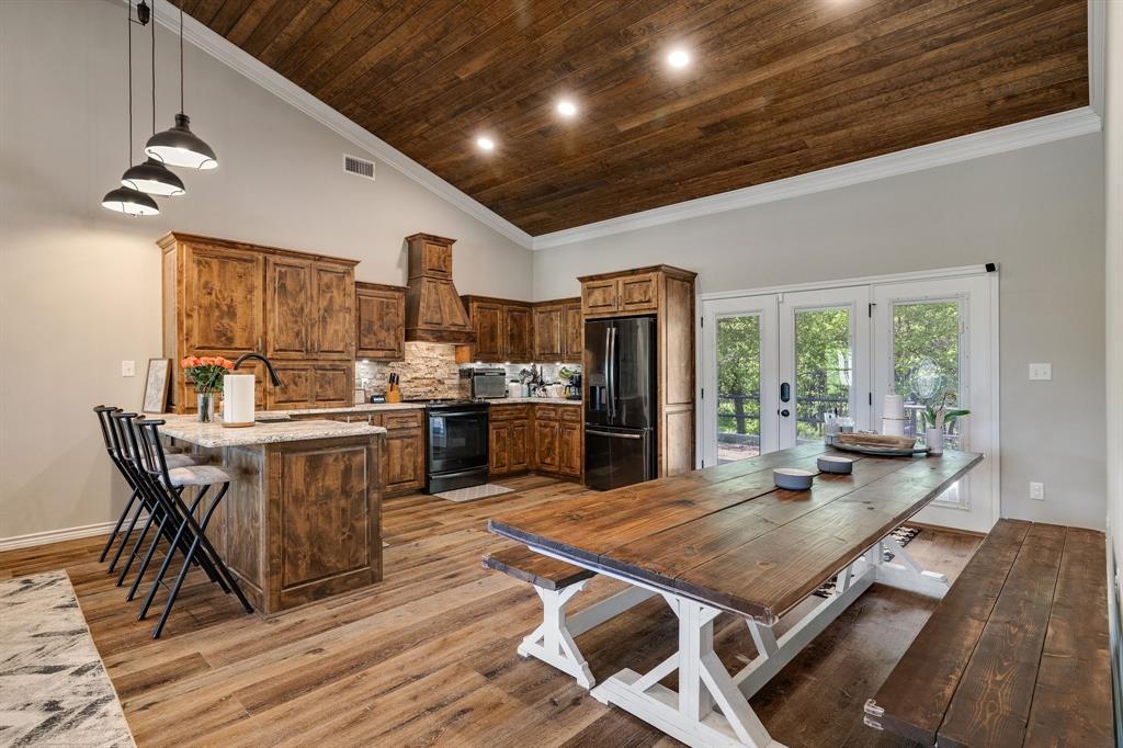 2668 Upper Montague Road Bowie, TX 76230 - Photo 9 of 40 a kitchen with stainless steel appliances granite countertop a stove refrigerator and cabinets