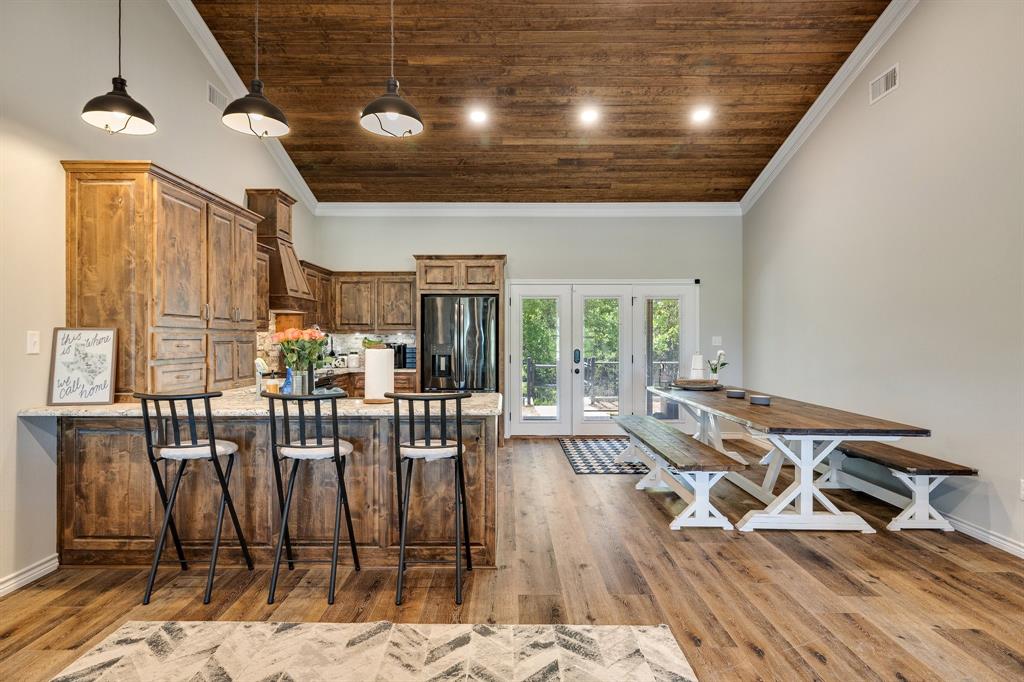2668 Upper Montague Road Bowie, TX 76230 - Photo 10 of 40 a view of a dining room with furniture window and wooden floor
