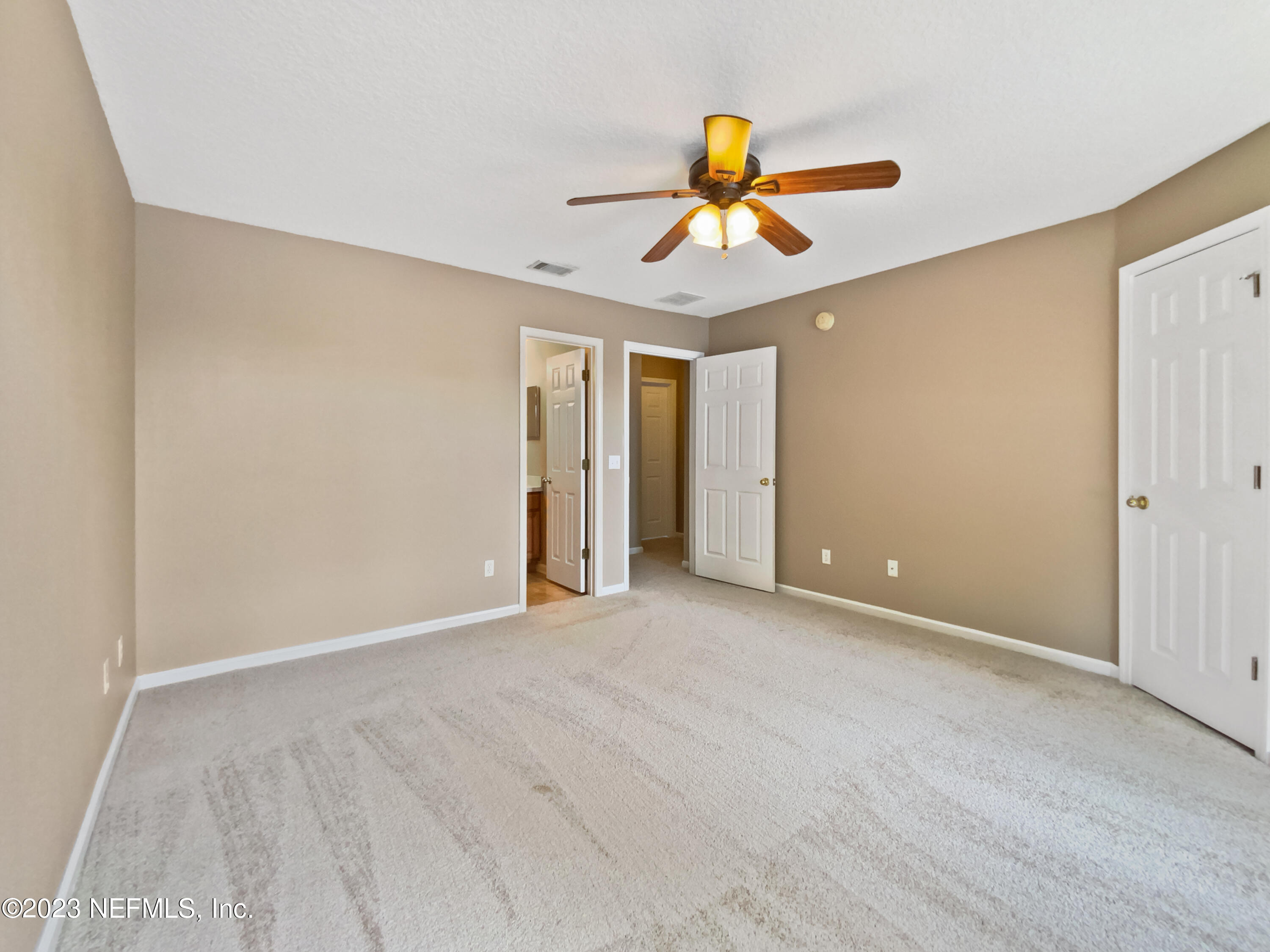 763 Scrub Jay Drive St. Augustine, FL 32092 - Photo 15 of 28 a view of an empty room with a ceiling fan and window