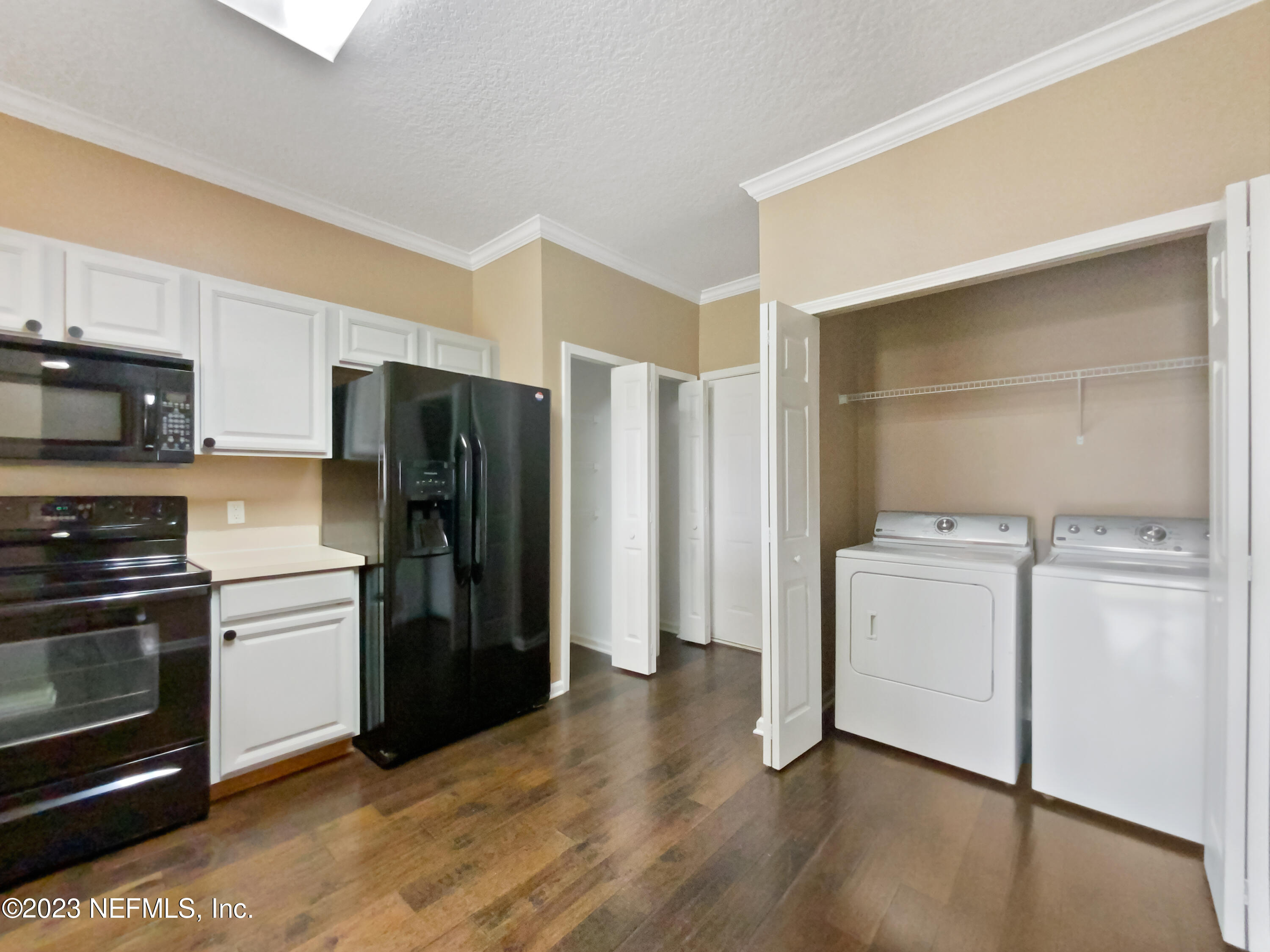 763 Scrub Jay Drive St. Augustine, FL 32092 - Photo 18 of 28 a kitchen with a refrigerator and a stove top oven