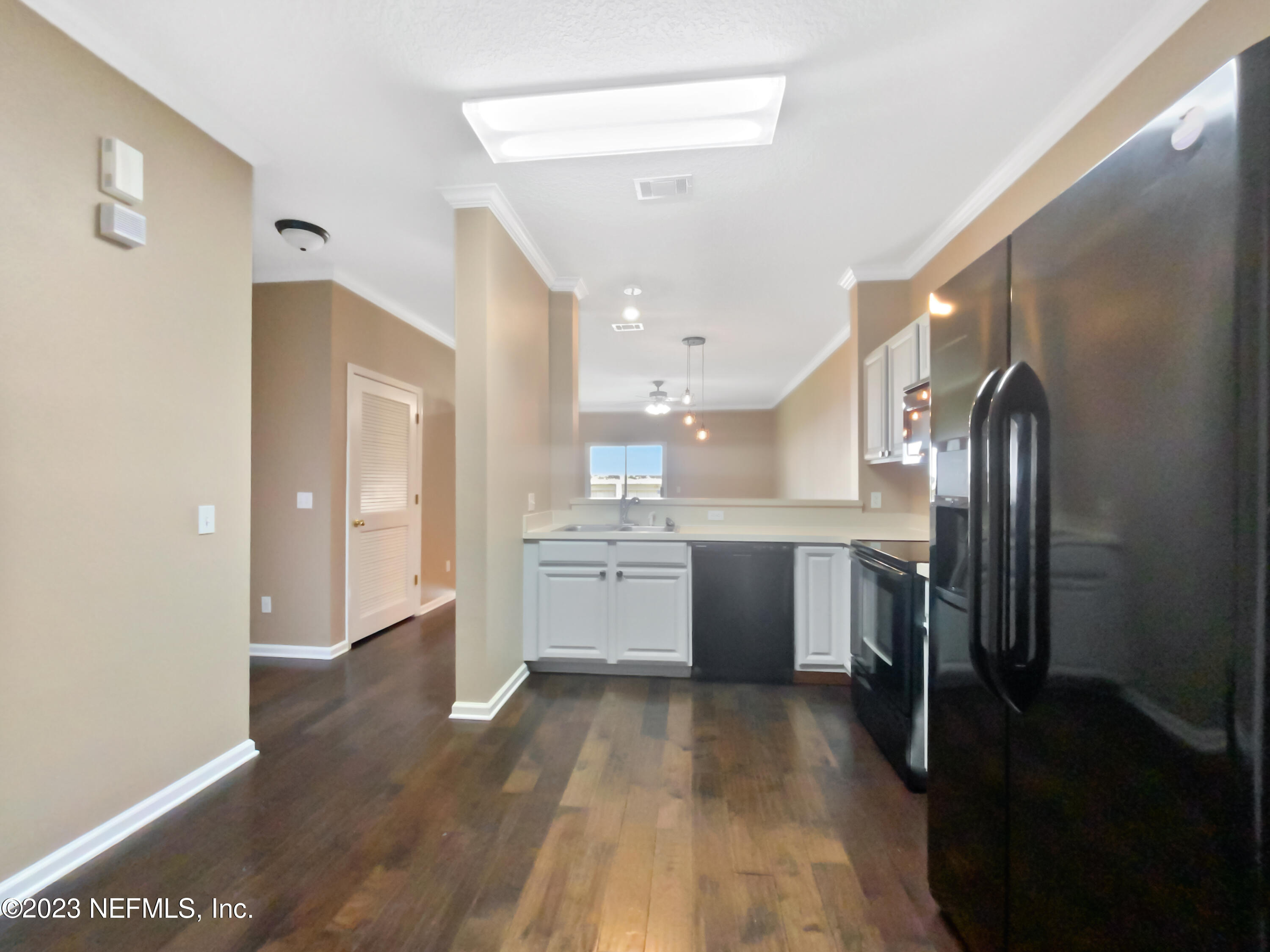 763 Scrub Jay Drive St. Augustine, FL 32092 - Photo 19 of 28 a view of a kitchen with a sink and refrigerator