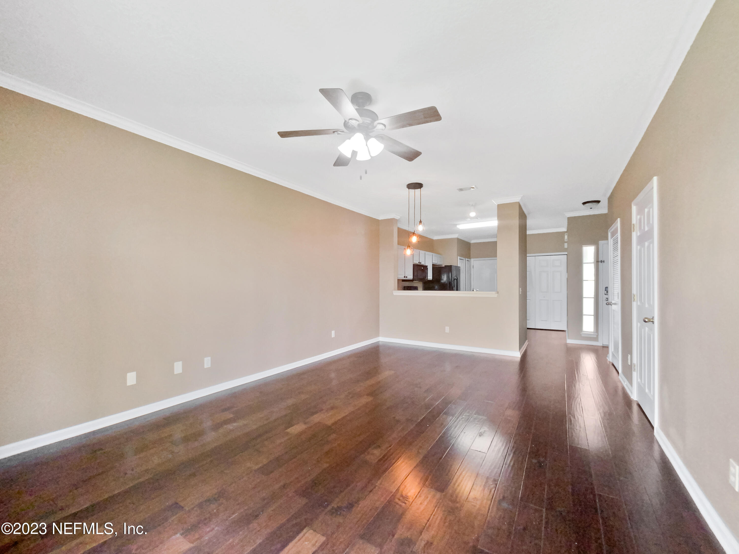 763 Scrub Jay Drive St. Augustine, FL 32092 - Photo 20 of 28 a view of a kitchen with wooden floor and a ceiling fan