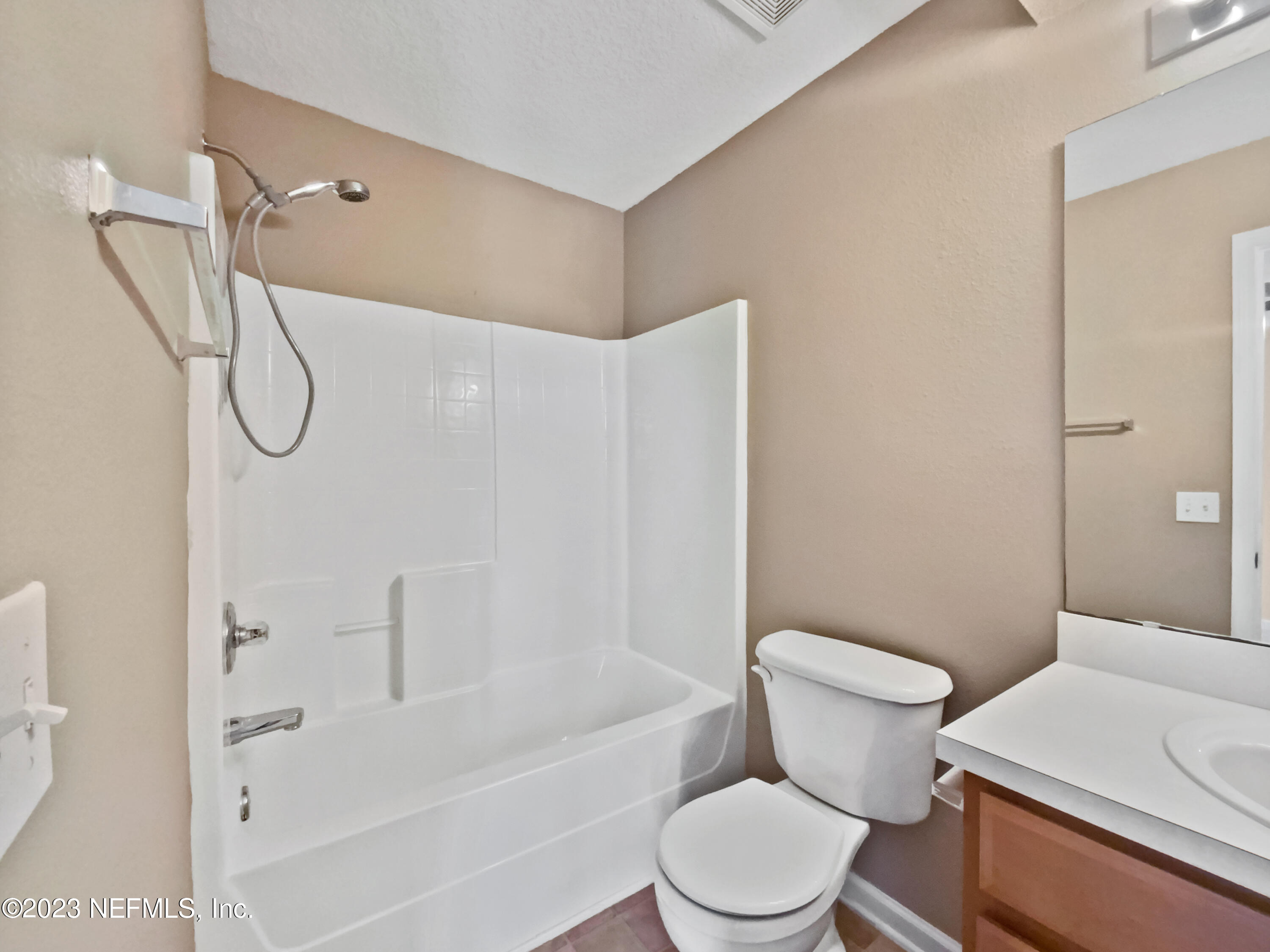 763 Scrub Jay Drive St. Augustine, FL 32092 - Photo 24 of 28 a white toilet sitting next to a bath tub shower