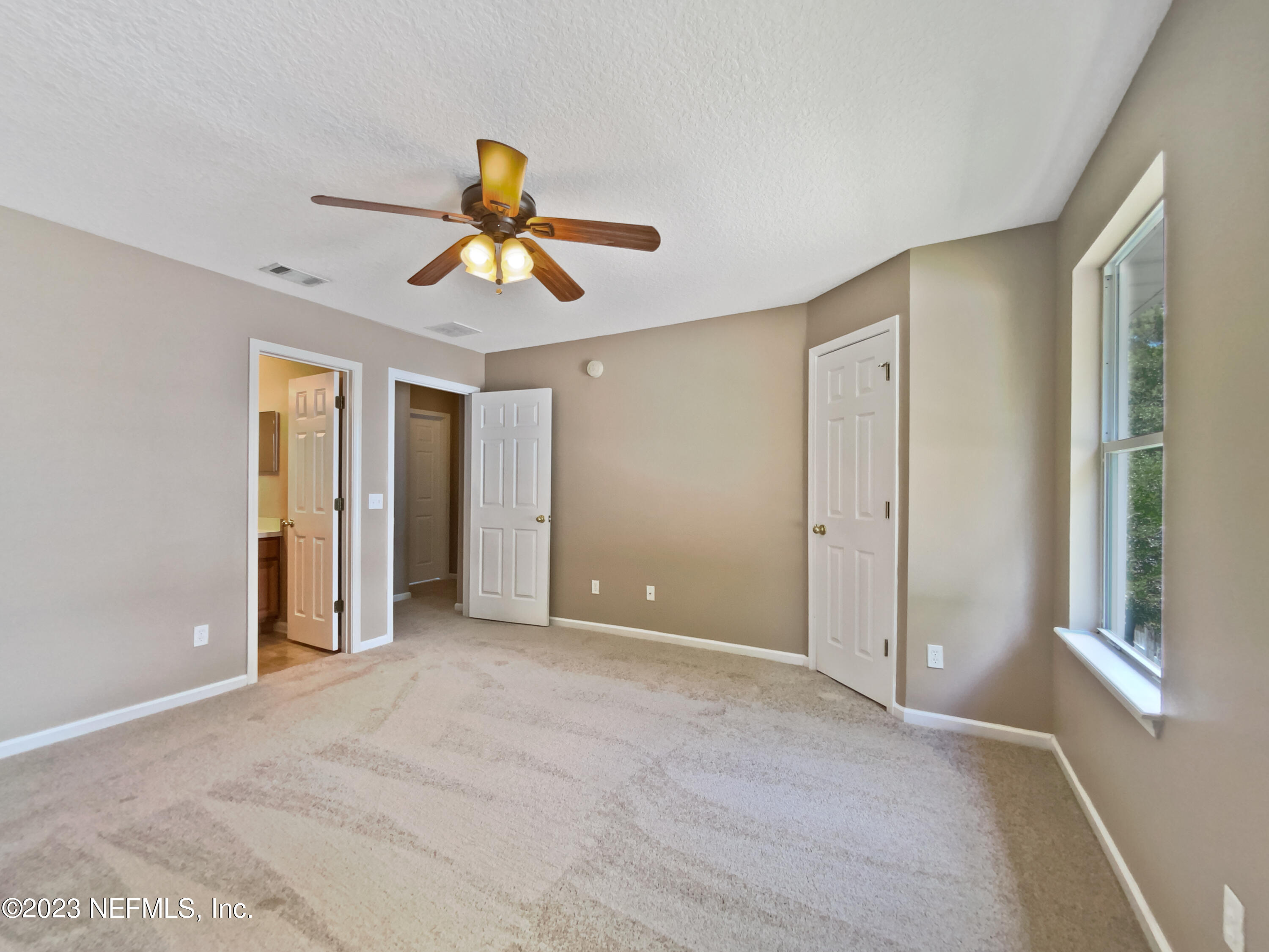 763 Scrub Jay Drive St. Augustine, FL 32092 - Photo 26 of 28 a view of a livingroom with a chandelier fan and windows