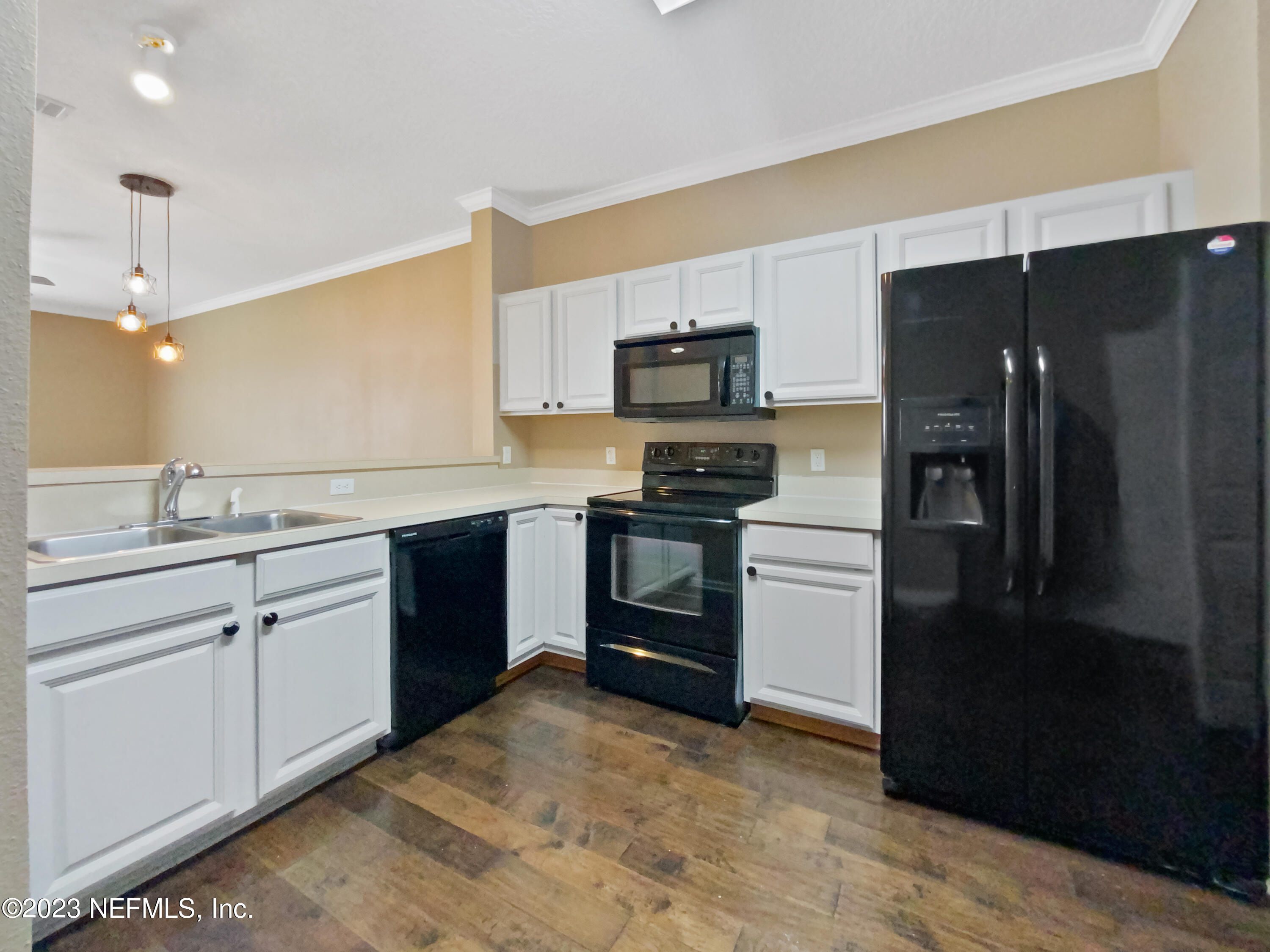 763 Scrub Jay Drive St. Augustine, FL 32092 - Photo 6 of 28 a kitchen with a sink stainless steel appliances and cabinets