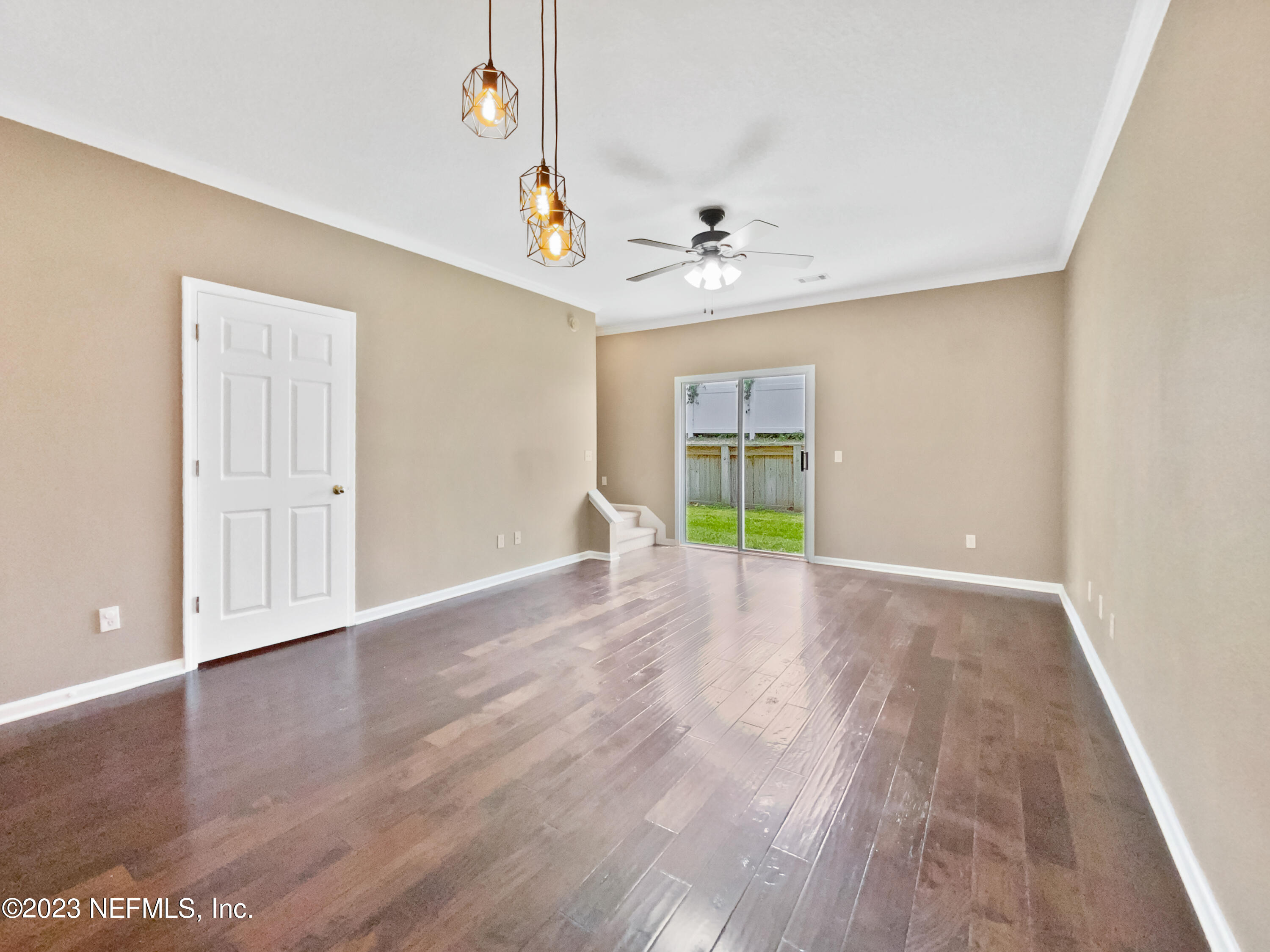 763 Scrub Jay Drive St. Augustine, FL 32092 - Photo 7 of 28 a view of an empty room with window and wooden floor