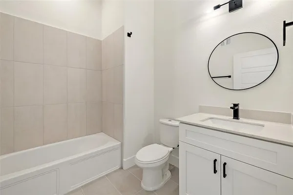 a bathroom with a granite countertop toilet a sink and a mirror