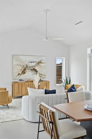 a living room with furniture a rug and a table