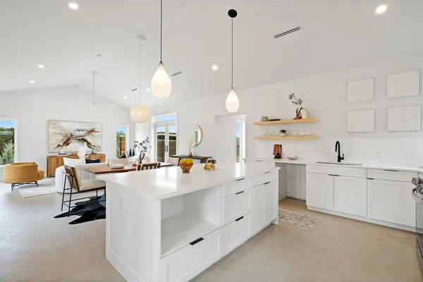 a large white kitchen with lots of counter space