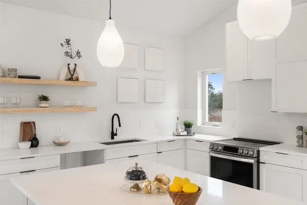 a kitchen with stainless steel appliances a sink stove and window
