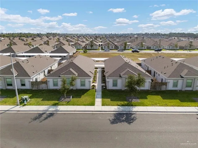 an aerial view of a house and a yard