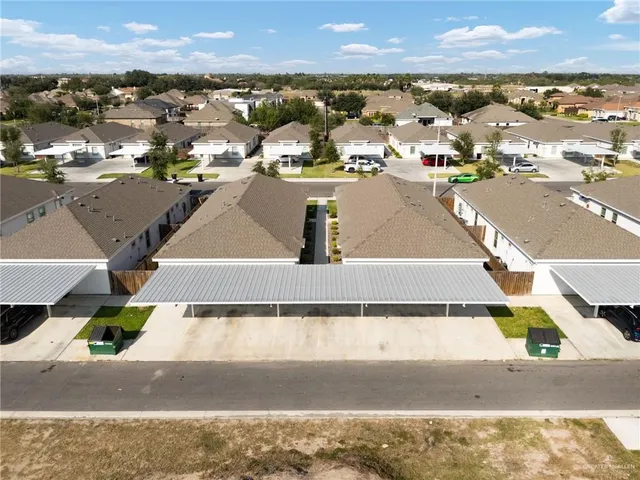 an aerial view of residential houses with outdoor space