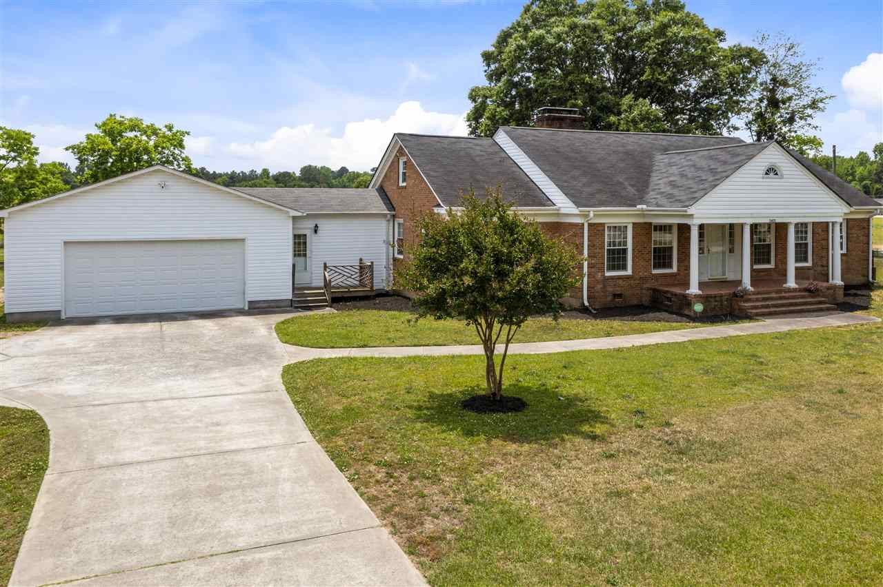 2403 Erwin Road Dunn, NC 28334 - Photo 2 of 23 The wide driveway leads to the oversize garage and to the double carport to the right. Exterior Front