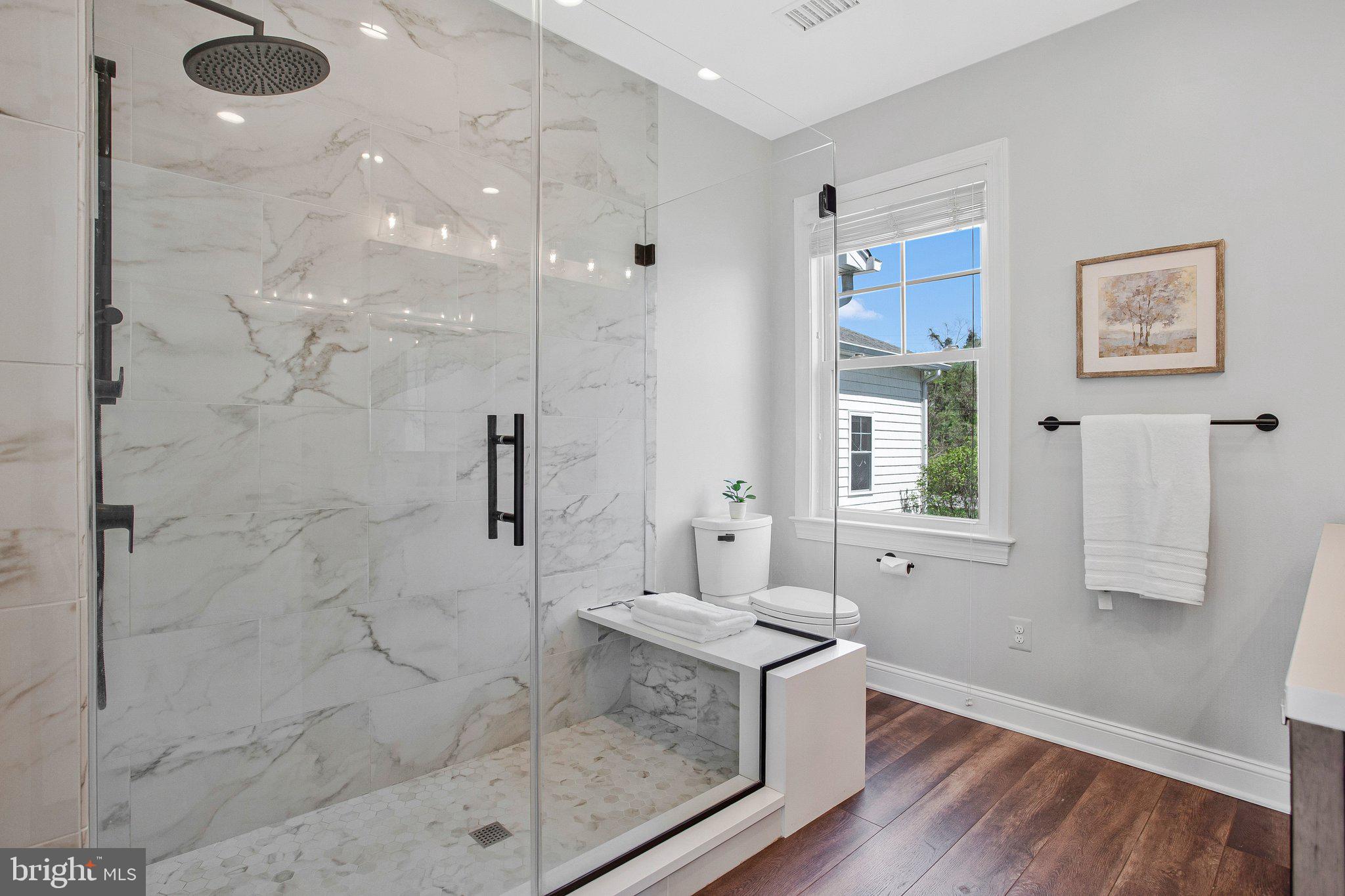 6146 Drum Point Road Deale, MD 20751 - Photo 37 of 75 a spacious bathroom with a granite countertop sink a toilet and shower