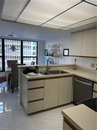 a kitchen with stainless steel appliances hardwood floor sink stove and microwave