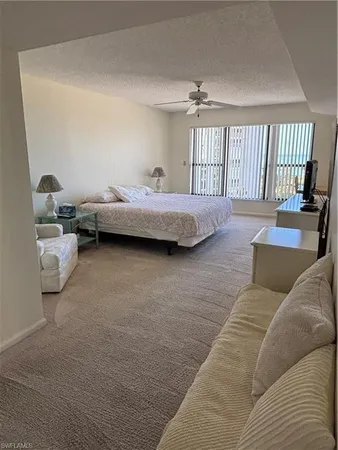 a bedroom with two beds and lamp
