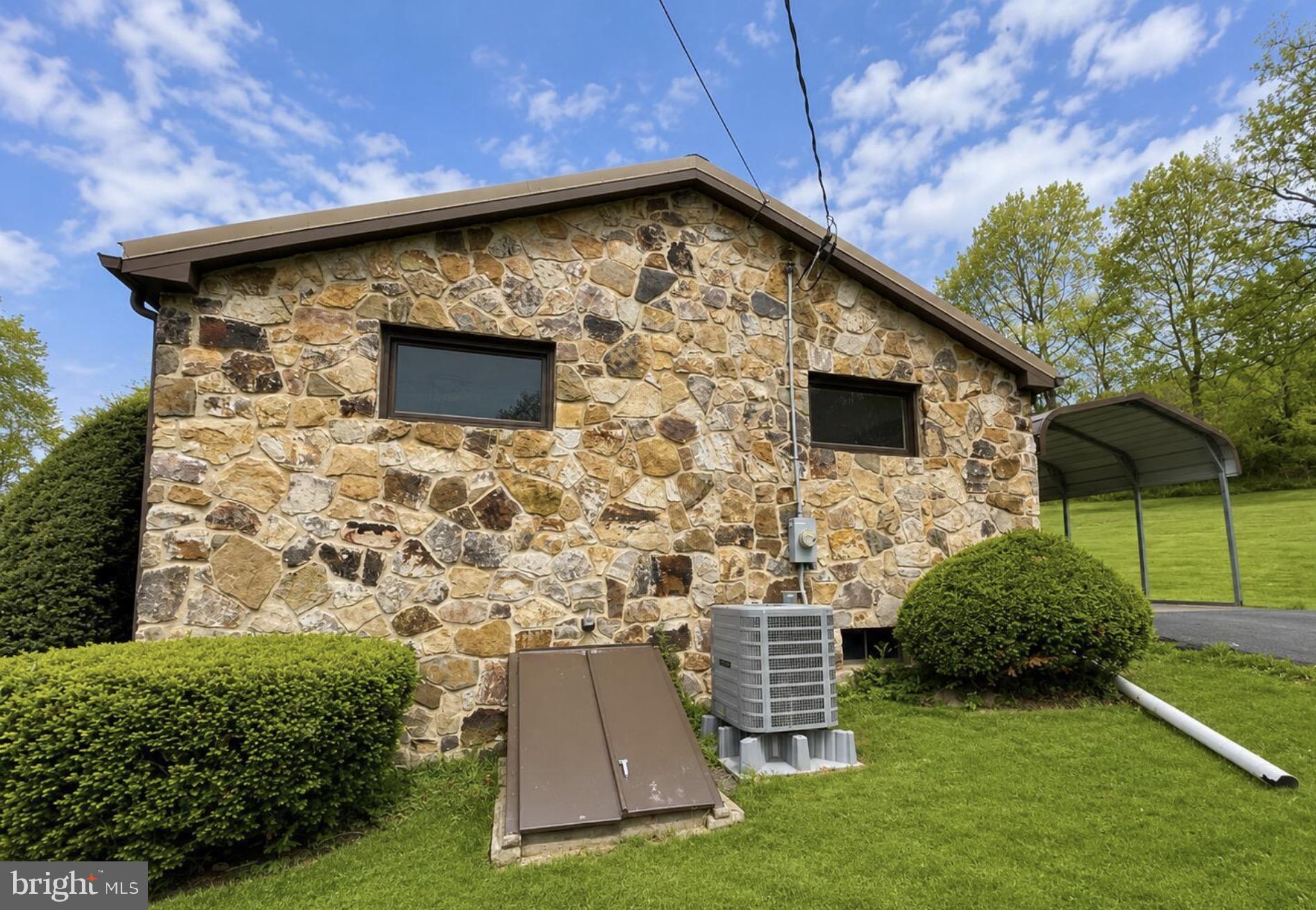 4805 Buffalo Run Road Port Matilda, PA 16870 - Photo 22 of 29 Charming stone exterior with lush greenery.